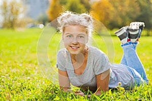 Girl close-up view laying on green grass