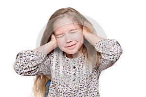 Girl with closed eyes is covering ears with hands