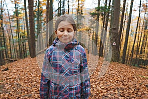 Girl with closed eyes in forest