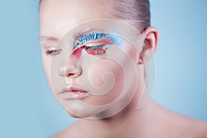 Girl with closed eyes and makeup in the form of a fish