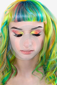Girl with closed eyes and rainbowed hair photo