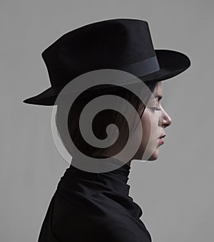 Girl with closed eyes wearing a hat