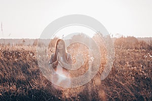 Girl closed her eyes, praying outdoors, Hands folded in prayer concept for faith, spirituality and religion. hope, dreams concept.