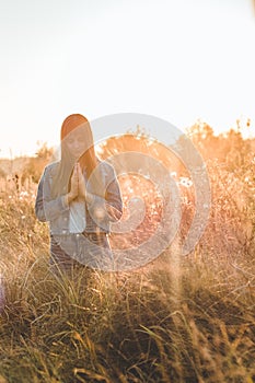 Girl closed her eyes, praying outdoors, Hands folded in prayer concept for faith, spirituality and religion. hope, dreams concept.