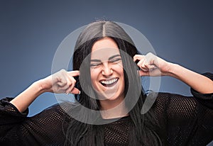 Girl closing her ears with fingers