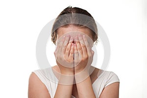Girl closing her face with hands sorrow or pain emotion