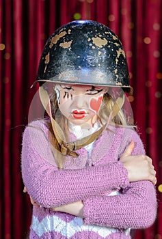 Girl in Clown Make Up and Helmet with Arms Crossed