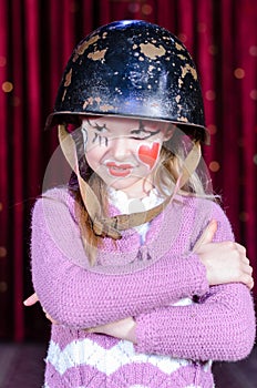 Girl in Clown Make Up and Helmet with Arms Crossed