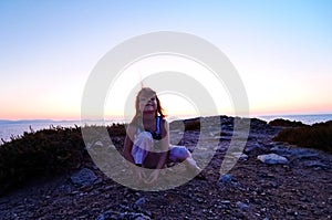 Girl on coastline at sunset