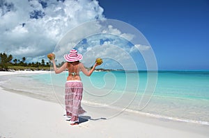Girl with coconuts at a beach