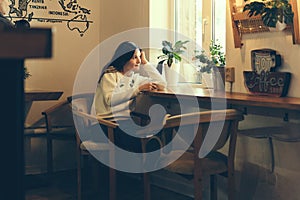 Girl in a coffee shop by the window