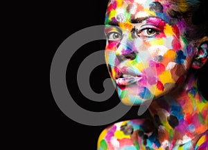 Girl with colored face painted. Art beauty image