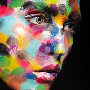 Girl with colored face painted. Art beauty image