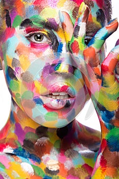 Girl with colored face painted. Art beauty image