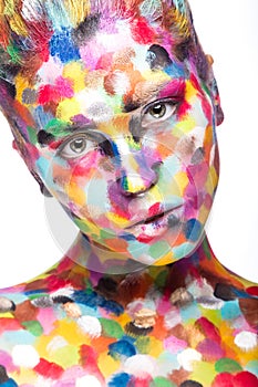 Girl with colored face painted. Art beauty image.