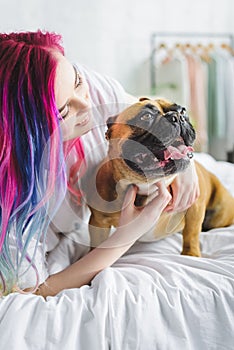 Girl with colorful hair petting