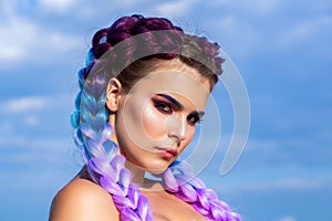 Girl colorful kanekalon braided in her hair. Pretty woman colorful violet ombre hair and pro makeup. Girl braids on