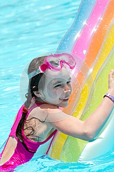 Girl on colorful pool float