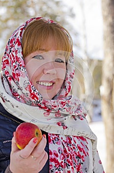 The girl in the colorful scarf with an Ð°pple in his hand