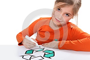 Girl colouring recycling sign