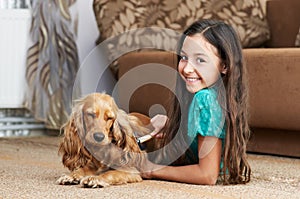 The girl is combing the dog