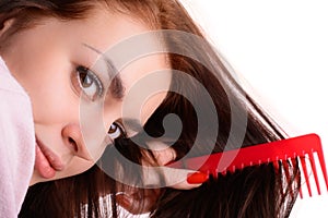 Girl combing her hair red comb