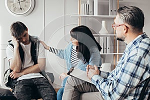 Girl comforts the worried boy during the meeting with the therapist