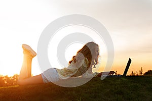 Girl with computer in nature.