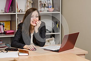 Girl at computer nervously biting his nails