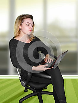 Girl with computer on office chair