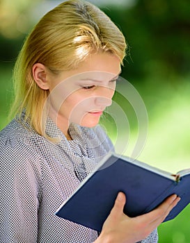 Girl concentrated sit park read book nature background. Reading inspiring books. Female literature. Relax leisure an