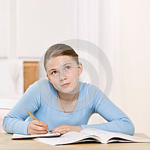 Girl concentrating on homework assignment photo