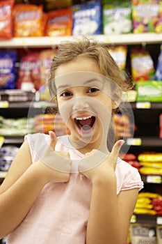 Girl in confectionery supermarket confectionery aisle