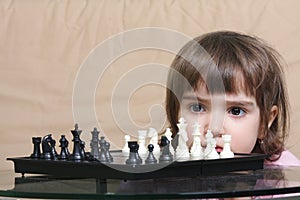 Girl considering chess position