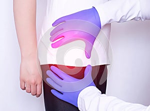 Girl on consultation with a doctor with a sick hip joint, synovitis and bursitis in the thigh, inflammation, osteoarthritis