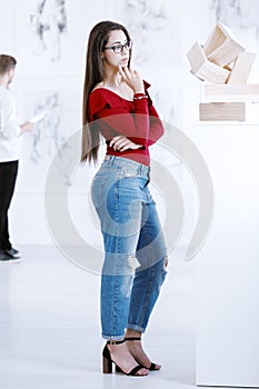 Girl contemplating piece of art