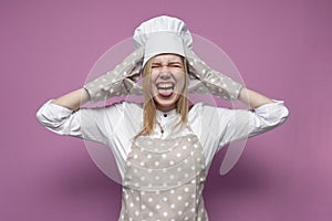 Girl cook in uniform, apron and gloves for baking screaming on a colored background, beautiful woman housewife in kitchen clothes