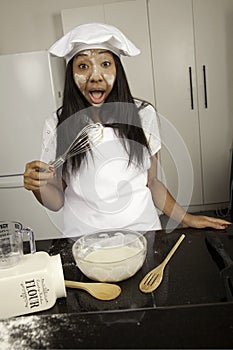 Girl cooking in kitchen.
