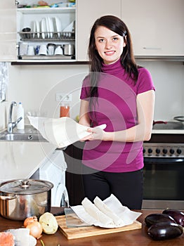 Girl cooking with prepared store-bought dough at kithen