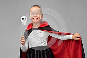 Girl in costume of dracula with cape on halloween