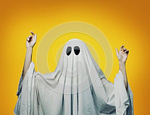 Girl in costume Spooky white ghost with black eyes on a gray background. Halloween minimal concept