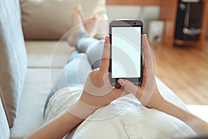 Girl on the couch with the phone in hand