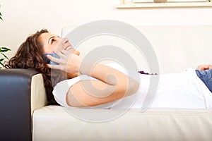 Girl on a couch using a mobile phone