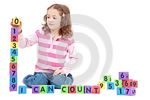 Girl counting numbers with kids blocks