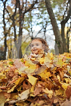 Girl covered with leaves