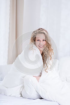 Girl covered by white duvet