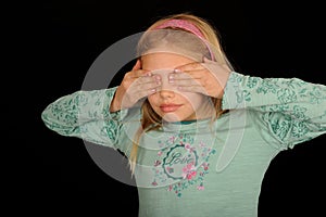 Girl covering eyes