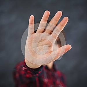 Girl covering face by hand, saying thanks but no