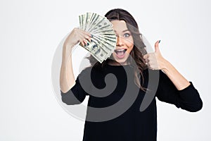 Girl covering her eye with dollar bills