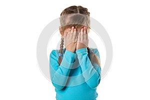 Girl covering her eyes by hands, isolated on the white background